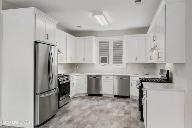 kitchen featuring light hardwood / wood-style floors, white cabinetry, sink, and appliances with stainless steel finishes