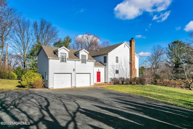 view of front of house featuring a front yard and a garage