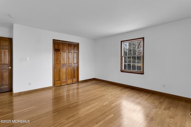 unfurnished bedroom with light hardwood / wood-style floors and a closet