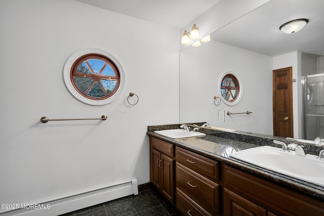 bathroom featuring baseboard heating, a shower with door, and vanity