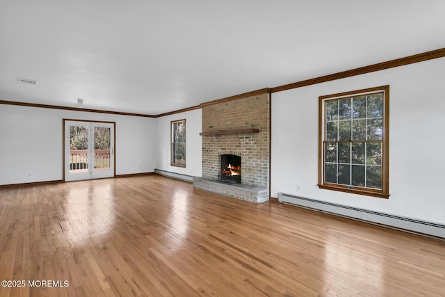 unfurnished living room with a brick fireplace, light hardwood / wood-style floors, and a baseboard heating unit