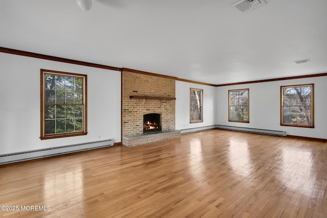 unfurnished living room with light hardwood / wood-style floors, ornamental molding, baseboard heating, and a brick fireplace