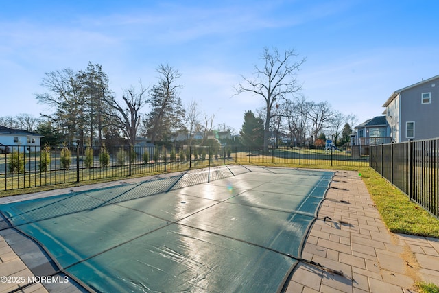 view of swimming pool with tennis court