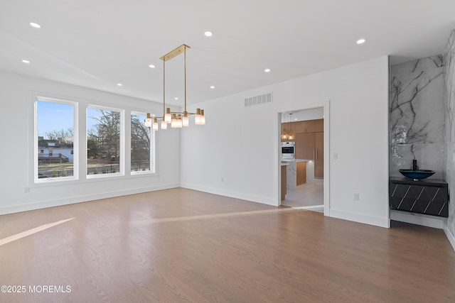 empty room with hardwood / wood-style flooring