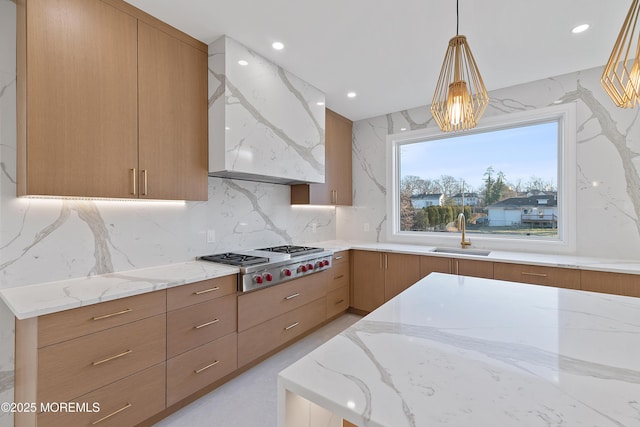 kitchen featuring custom exhaust hood, hanging light fixtures, sink, decorative backsplash, and stainless steel gas cooktop