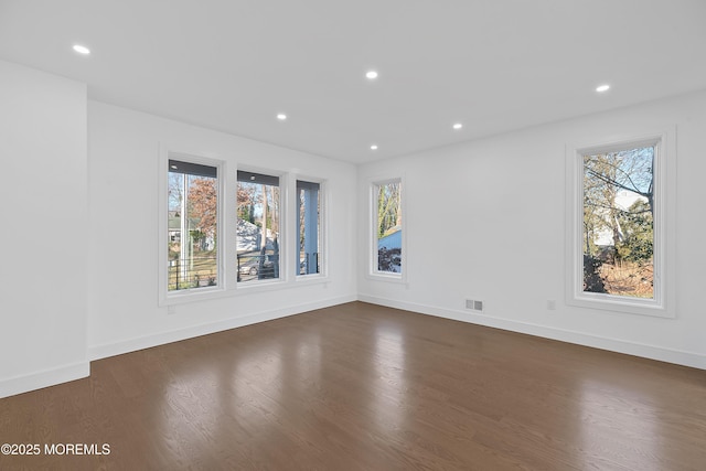 spare room featuring dark hardwood / wood-style floors