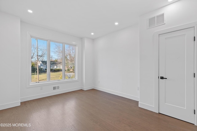 spare room with hardwood / wood-style flooring