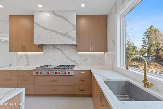 kitchen with a wealth of natural light, sink, stainless steel gas cooktop, and tasteful backsplash