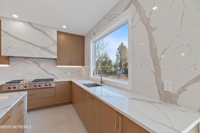 kitchen featuring tasteful backsplash, light stone counters, ventilation hood, stainless steel gas cooktop, and sink