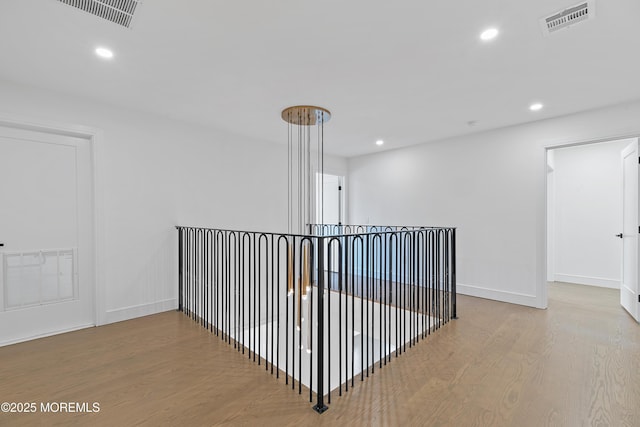 hallway with light hardwood / wood-style floors