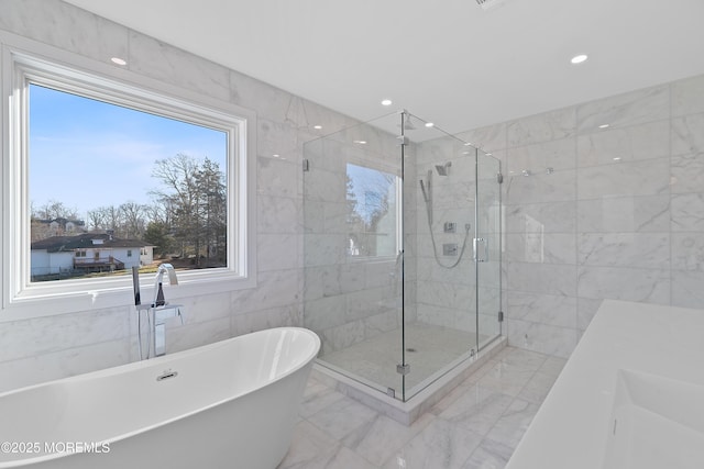 bathroom featuring shower with separate bathtub