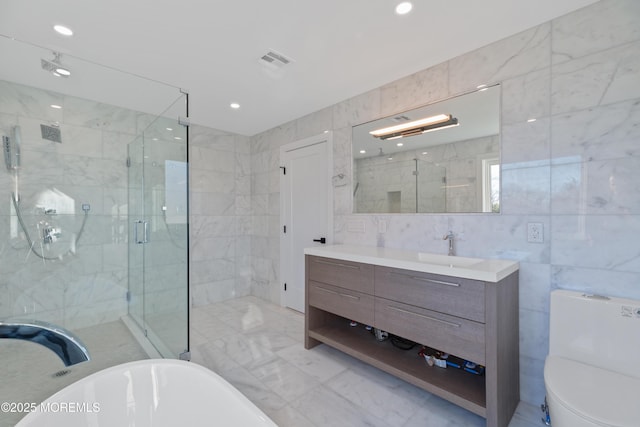 bathroom with shower with separate bathtub, vanity, and tile walls