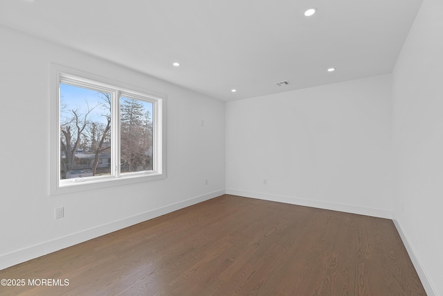 empty room featuring dark wood-type flooring