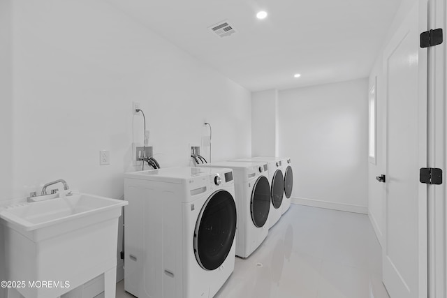 laundry room featuring independent washer and dryer and sink