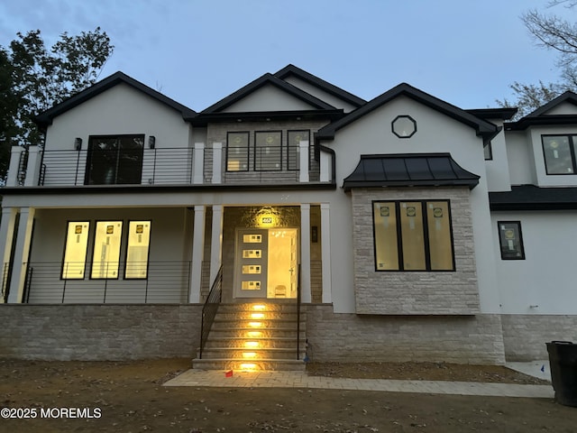 view of front of house featuring a balcony