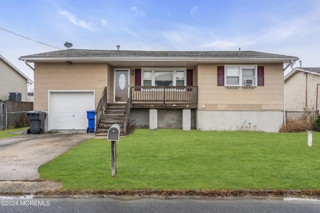 ranch-style house with cooling unit, a front lawn, and a garage