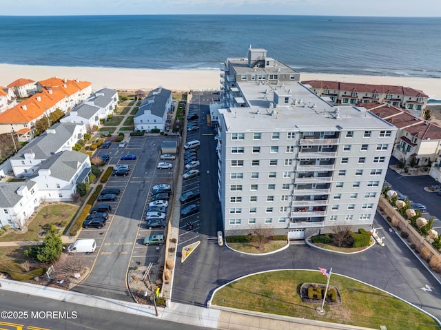 birds eye view of property with a view of the beach and a water view