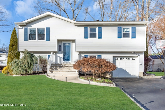 bi-level home with a garage and a front yard