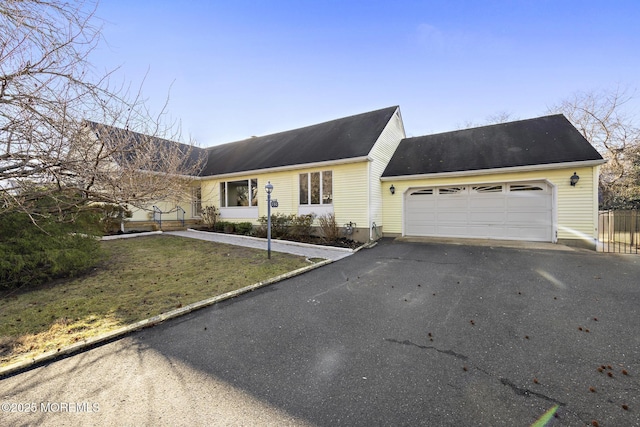 view of front of home with a front yard and a garage