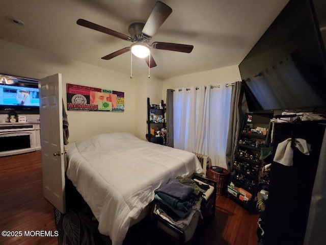 bedroom with ceiling fan and dark hardwood / wood-style floors