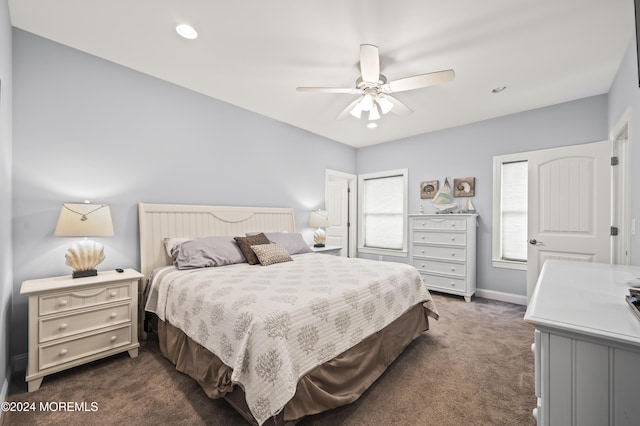 bedroom featuring ceiling fan and dark colored carpet