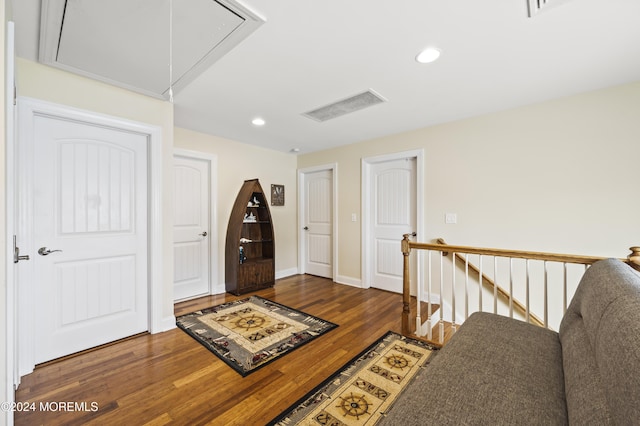 corridor with dark hardwood / wood-style flooring