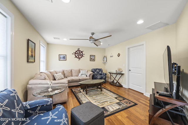 living room with hardwood / wood-style flooring, plenty of natural light, and ceiling fan