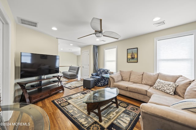 living room featuring a wealth of natural light, ceiling fan, and wood-type flooring