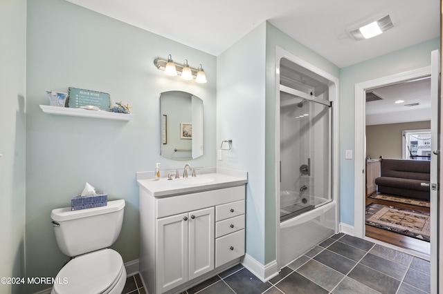 full bathroom featuring tile patterned flooring, vanity, bath / shower combo with glass door, and toilet