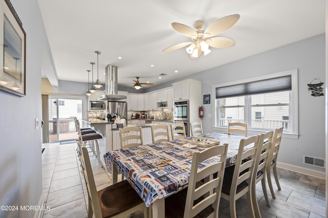 dining area featuring ceiling fan and a healthy amount of sunlight