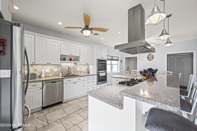 kitchen featuring white cabinets, appliances with stainless steel finishes, and island range hood