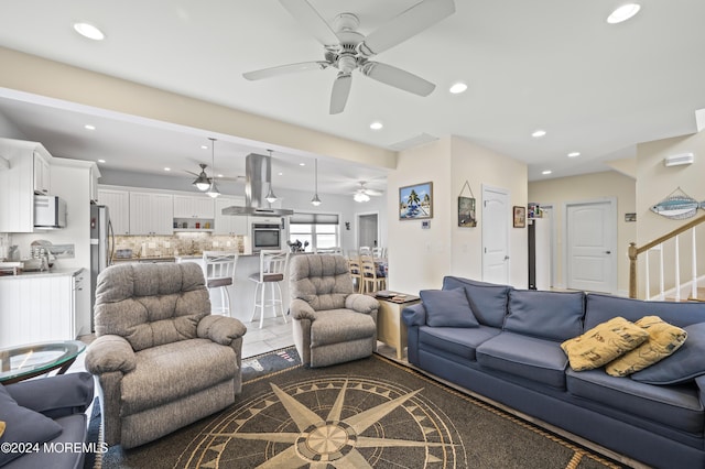 tiled living room featuring ceiling fan