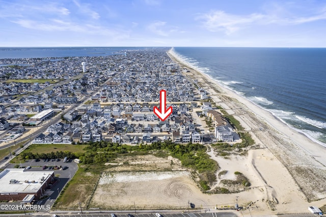 birds eye view of property with a view of the beach and a water view