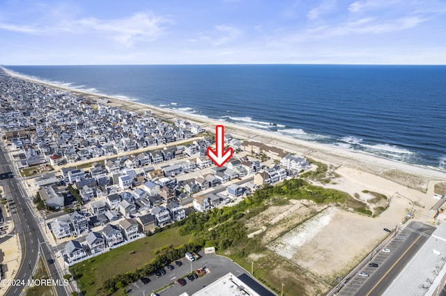 birds eye view of property with a beach view and a water view