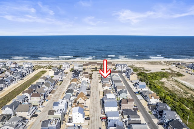 birds eye view of property with a water view and a view of the beach