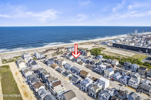 drone / aerial view featuring a beach view and a water view