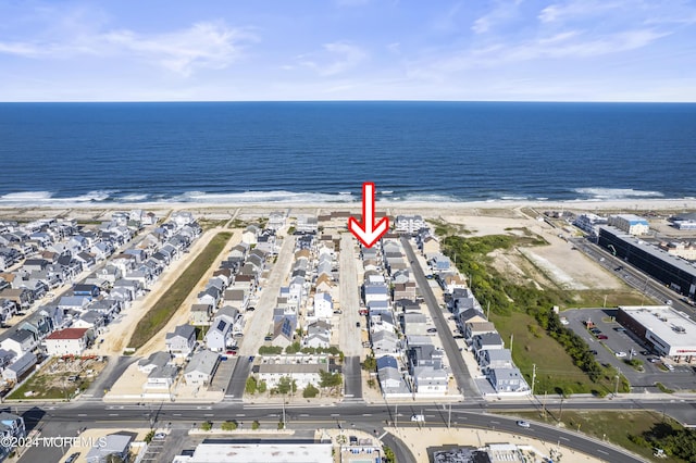 birds eye view of property with a view of the beach and a water view