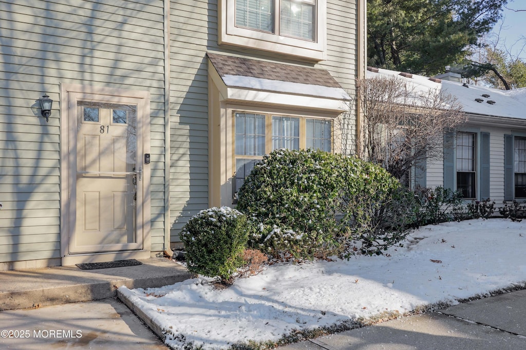 view of snow covered property entrance