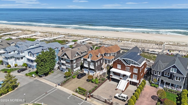 birds eye view of property with a view of the beach and a water view