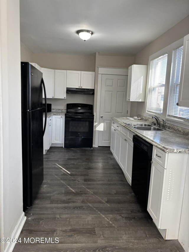 kitchen with dark wood-type flooring, sink, white cabinets, and black appliances