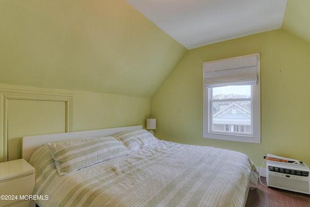 bedroom featuring dark wood-type flooring and lofted ceiling