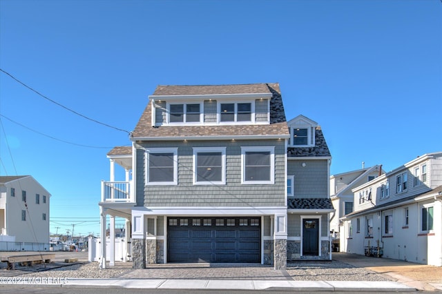 view of front of home featuring a balcony and a garage