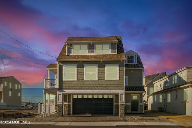 view of front facade featuring a balcony and a garage