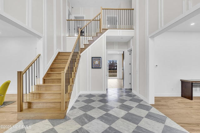 staircase featuring a high ceiling