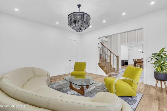 living room with a notable chandelier and light hardwood / wood-style flooring