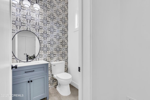 bathroom featuring tile patterned flooring, vanity, and toilet