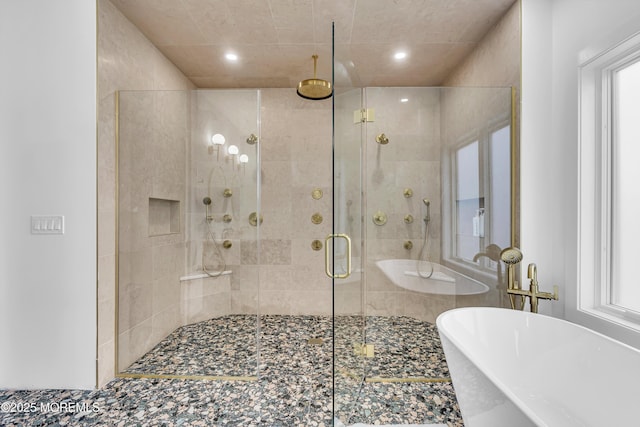 bathroom featuring a wealth of natural light and a shower with shower door