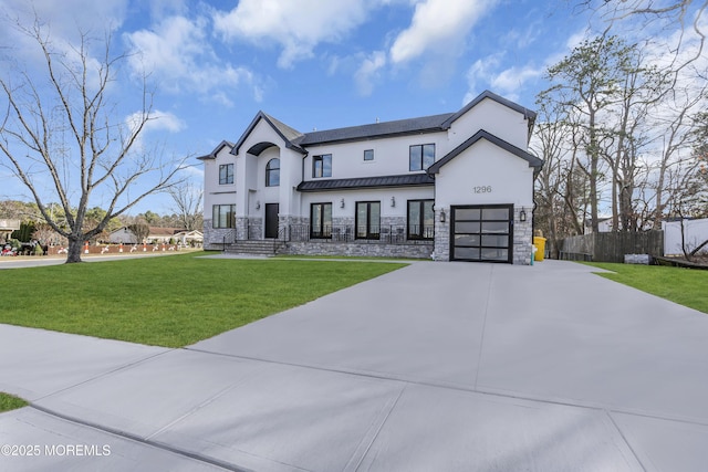 view of front of home featuring a garage and a front lawn