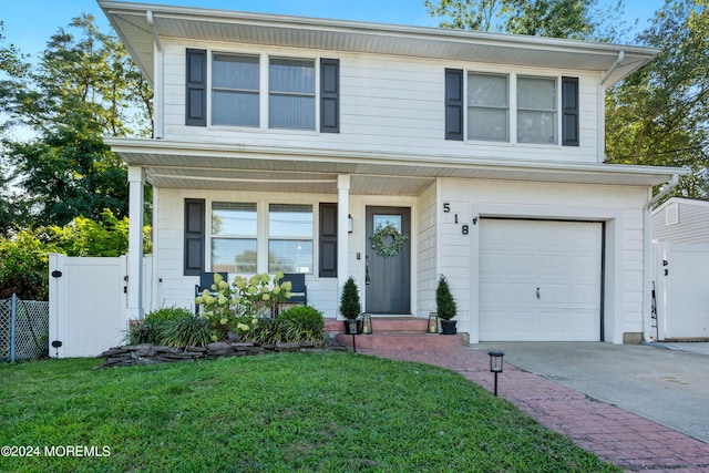 view of front of property with a front lawn and a garage