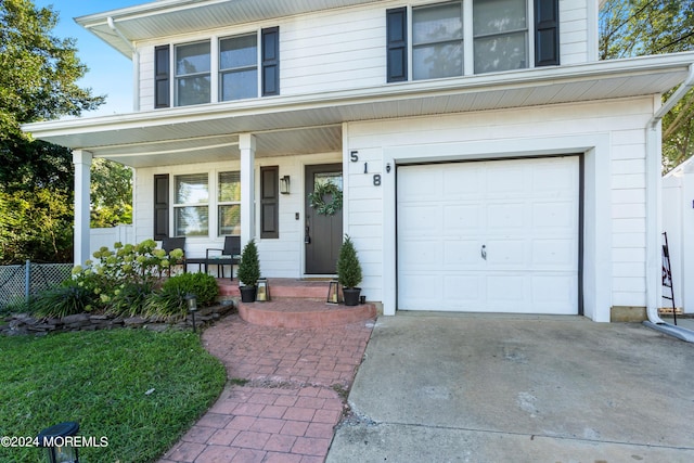 view of front of home featuring covered porch and a garage